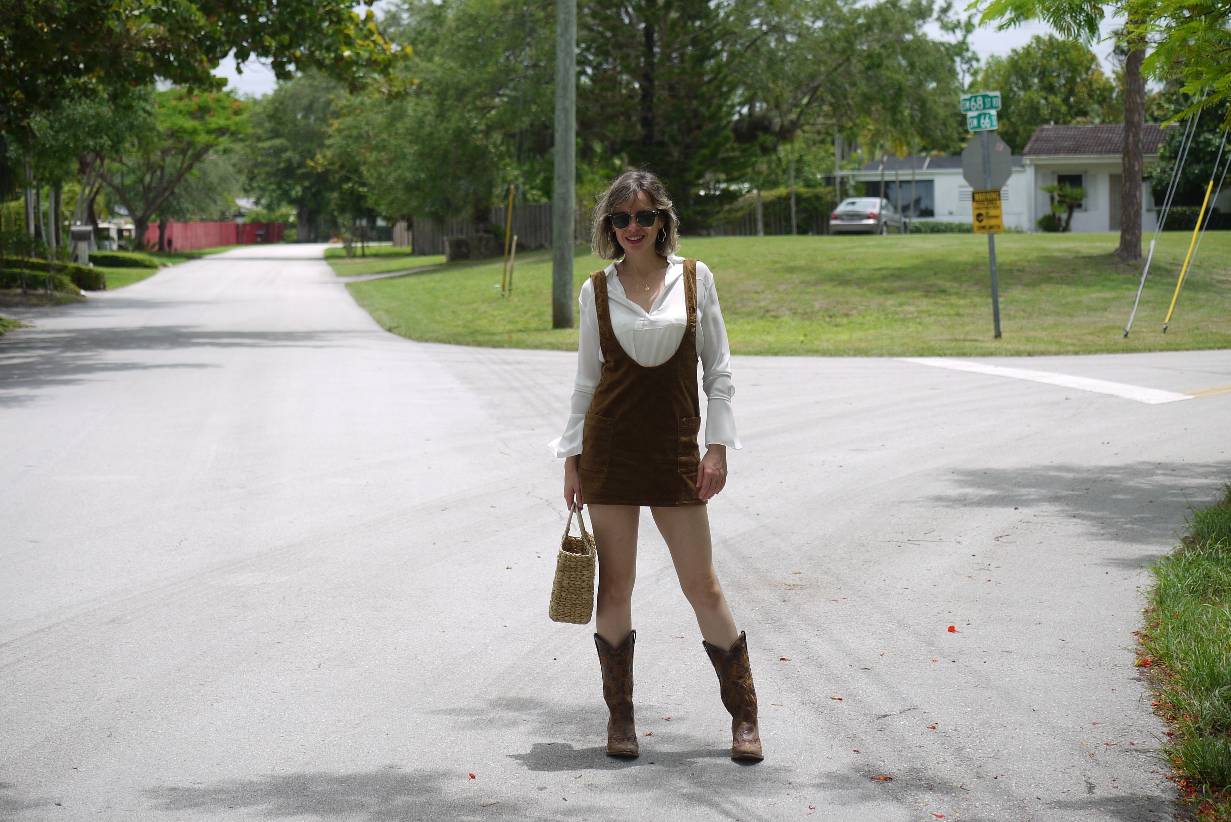 Alba Marina fashion blogger of Mylovelypeople blog is wearing a mini dress jumper + white blouse and cowboys boots in Miami